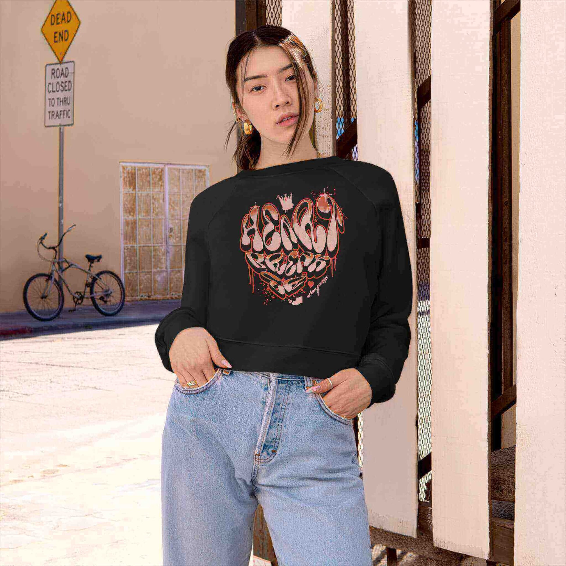 Young women in an urban setting wearing Urban Cookie's Black Breaking Hearts Crop.