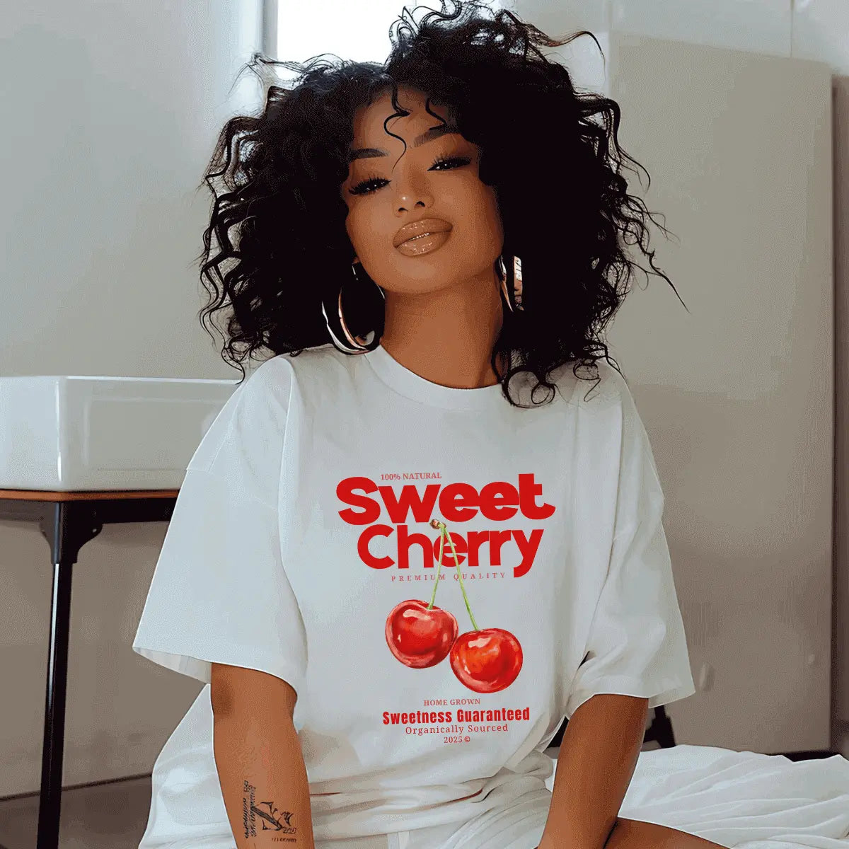 Trendy model wearing Urban Cookie’s white Cute Cherry T-shirt with bold red cherry graphics, evoking a playful Y2K aesthetic and vintage streetwear flair.