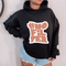 Front view of a female wearing Urban Cookie's Black hoodie with Coral color 